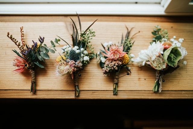 four flower bouquets on table